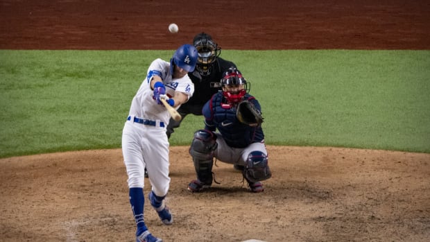 Oct 18, 2020; Arlington, Texas, USA; Los Angeles Dodgers center fielder Cody Bellinger (35) hits a home run in the seventh inning against the Atlanta Braves during game seven of the 2020 NLCS at Globe Life Field. Mandatory Credit: Kevin Jairaj-USA TODAY Sports